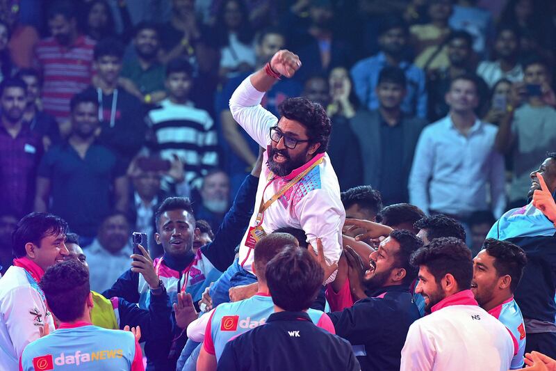 Bollywood actor Abhishek Bachchan celebrates after his team Jaipur Pink Panthers won the PKL final against Puneri Paltan in Mumbai on December 17, 2022. AFP