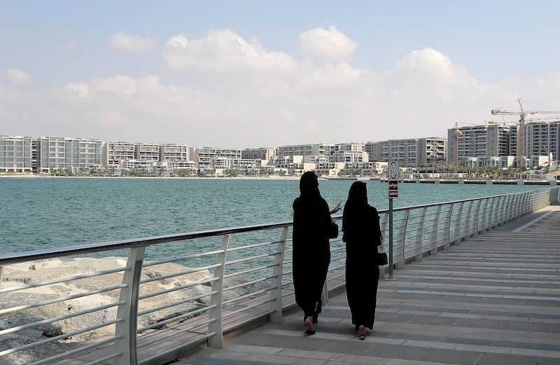 ABU DHABI , UNITED ARAB EMIRATES ,  November 21 , 2018 :- Visitors at the Al Muneera at the Raha Beach area in Abu Dhabi. Residential building at Al Zeina area seen in the background.  ( Pawan Singh / The National )  For News. Story by Gillian