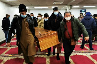 People carry the coffin of an Afghan migrant who died trying to cross the English Channel last November, after a funeral ceremony in Lille, France. Reuters