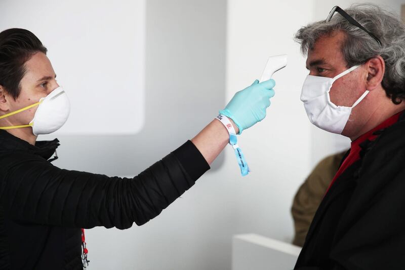 Media arriving at the stadium have their temperature checked before the Second Bundesliga match between SSV Jahn Regensburg and Holstein Kiel at Continental Arena in Regensburg, Germany.  Getty