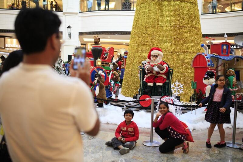 Children strike a pose near the Christmas displays at Mall of the Emirates. Sarah Dea / The National