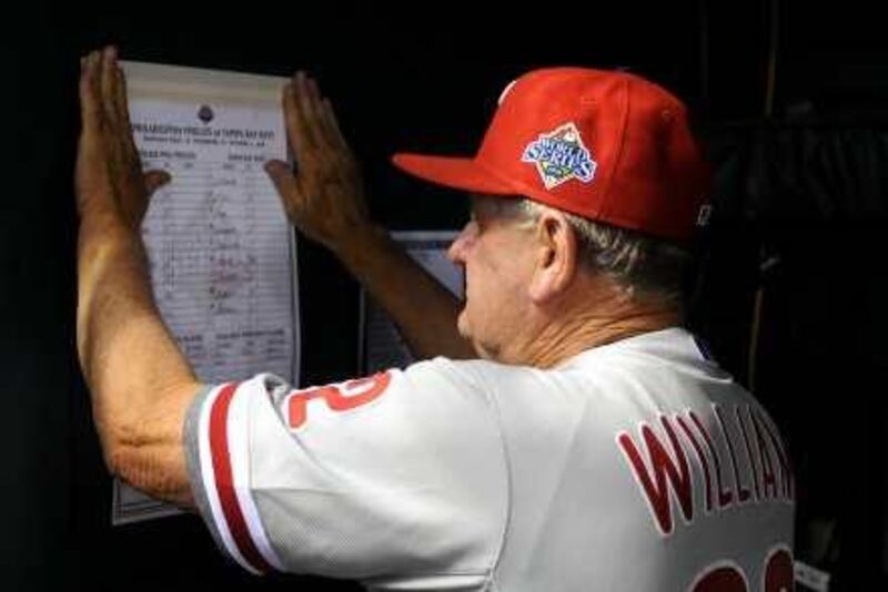 Jimy Williams, bench coach for the Philadelphia Phillies, posts a roster in the dugout before the start of game one of the Major League  Baseball (MLB) World Series against the Tampa Bay Rays at Tropicana Field in St. Petersburg, Florida, U.S., on Wednesday, Oct. 22, 2008. The Rays are  seeking their first World Series title, while the Phillies are looking to win the championship for the first time since 1980.  Photographer: Ryan K. Morris/Bloomberg News *** Local Caption ***  470918.jpg