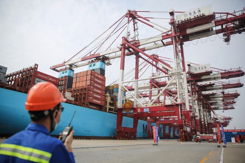 (FILES) This file photo taken on July 2, 2020 shows a staff member working at a port in Qingdao in China's eastern Shandong province. China's exports expanded more than expected in August, 2020 as key markets eased virus containment measures, official data showed on September 7, but imports unexpectedly shrank despite a push to boost domestic demand. - China OUT
 / AFP / STR
