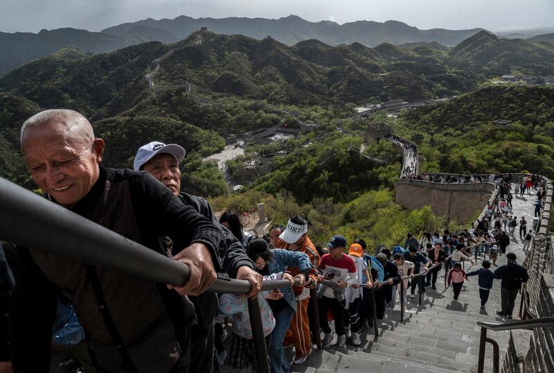 BEIJING, CHINA - APRIL 29: Visitors climb a staircase  on the Great Wall as they visit the popular tourist site on the first day of the May Labour Day holiday on April 29, 2023 in Beijing, China. The holiday, which lasts five days, runs until May 3.(Photo by Kevin Frayer / Getty Images)