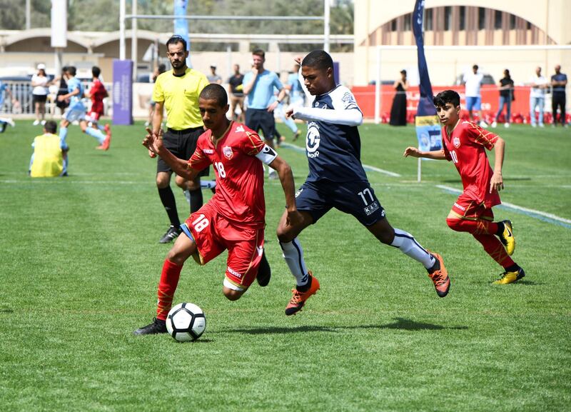 Abu Dhabi, United Arab Emirates - Bahrain National team (red) vs. Legends soccer team from South Africa (white/blue) under 14 age group on Abu Dhabi World Cup Day 1 at Zayed Sports City. Khushnum Bhandari for The National
