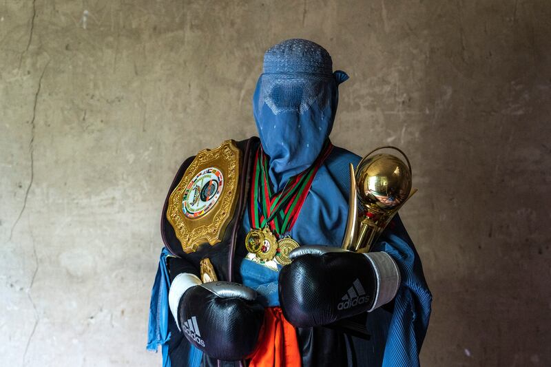 A mixed martial artist with her trophies in Kabul. A female competitor has said she was forced to flee a tournament in the Afghan capital as the Taliban advanced in 2021.