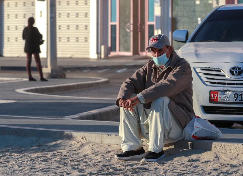 Abu Dhabi, United Arab Emirates, January 10, 2021.  A man waits for a bus on a cold Sunday morning at Khalifa City.
Victor Besa/The National
Section:  NA/Weather
Reporter: