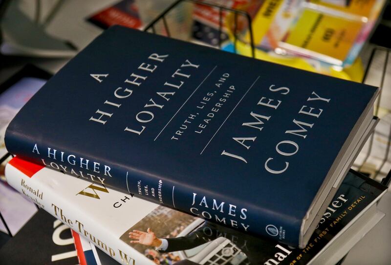 A copy of former FBI Director James Comey's new book, "A Higher Loyalty: Truth, Lies and Leadership," is on display, Friday, April 13, 2018, in New York. In the book, Comey compares U.S. President Donald Trump to a mob boss demanding loyalty, suggests he's unfit to lead and mocks the president's appearance. (AP Photo/Bebeto Matthews)