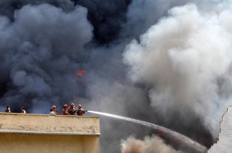 Firefighters work to put out a blaze in a warehouse of the United Nations High Commissioner for Refugees (UNHCR) in Peshawar, July 8, 2012. The cause behind the fire is unknown. No casualties were reported, according to local media.

 REUTERS/Fayaz Aziz     (PAKISTAN - Tags: DISASTER TPX IMAGES OF THE DAY)