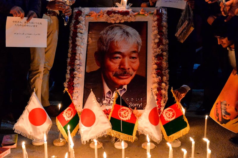 CORRECTION / Afghan people hold a candlelight vigil for slain Japanese doctor Tetsu Nakamura, who was killed on December 4 in Jalalabad during a gunmen attack, in Kabul on December 5, 2019.  A Japanese doctor whose long career was dedicated to helping some of Afghanistan's poorest people was among six people killed on December 4 in an attack in the east of the country, officials said. / AFP / NOORULLAH SHIRZADA
