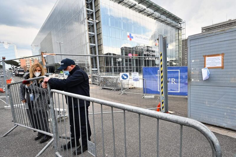 Employees of the Lazio Region close the entrance of the new vaccination centre in Rome, Italy. AFP