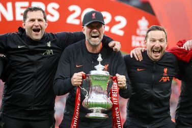 Soccer Football - FA Cup - Final - Chelsea v Liverpool - Wembley Stadium, London, Britain - May 14, 2022 Liverpool manager Juergen Klopp and his coaching team celebrate with the trophy after winning the FA Cup final REUTERS / Hannah Mckay