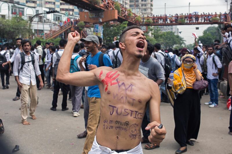 A Bangladeshi student shout slogans while blocking a road with others during a rally demanding safe roads on the seventh consecutive day of protests, in Dhaka city, Bangladesh.  EPA / MONIRUL ALAM