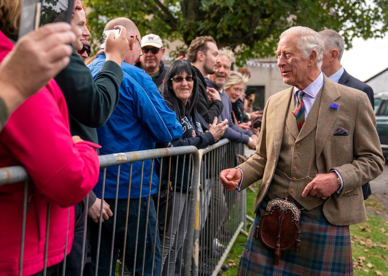 The king meets members of the public in Tomintoul, Scotland. PA