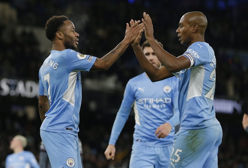 Manchester City's Raheem Sterling, left, celebrates with teammates after scoring against Leicester City. EPA