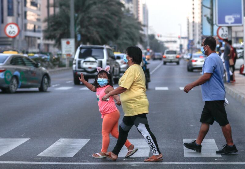 Abu Dhabi, United Arab Emirates, August 14, 2020.  Pedestrians crossing the street wearing face masks at downtown Abu Dhabi on an early Friday evening.
Victor Besa /The National
Section:  NA
For:  Standalone/Stock Images
