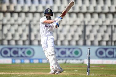 (FILES) In this file photo taken on December 5, 2021 India's captain Virat Kohli plays a shot during the third day of the second Test cricket match between India and New Zealand at the Wankhede Stadium in Mumbai.  - Superstar cricketer Virat Kohli will play his 100th Test behind closed doors due to the coronavirus pandemic in the north Indian city of Mohali, an official told AFP on February 27, 2022.  (Photo by Punit PARANJPE  /  AFP)  /  ----IMAGE RESTRICTED TO EDITORIAL USE - STRICTLY NO COMMERCIAL USE-----