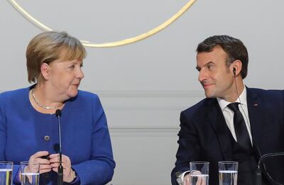 FILE PHOTO: German Chancellor Angela Merkel and French President Emmanuel Macron give a press conference after a summit on Ukraine at the Elysee Palace in Paris, December 9, 2019.  Ludovic Marin/Pool via REUTERS/File Photo