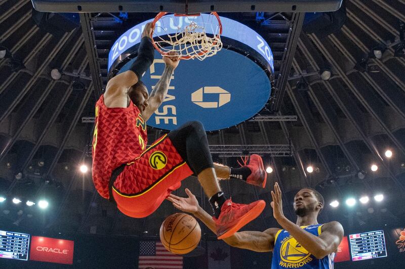 Atlanta Hawks forward DeAndre' Bembry dunks the basketball against Golden State Warriors forward Alfonzo McKinnie at Oracle Arena, Oakland. Reuters