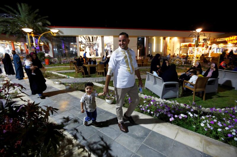 Iraqi families are seen at a recreational park after its reopening during Eid Al Fitr, following the outbreak of the coronavirus disease, in the city of Najaf, Iraq. Reuters