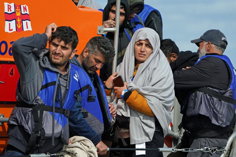 A group of people thought to be migrants are brought in to Dungeness. PA