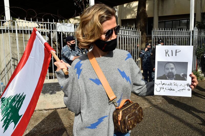 A protesters holds a picture of slain prominent Lebanese activist and intellectual Lokman Slim,  during a rally in front of the Justice Palace in the capital Beirut. AFP
