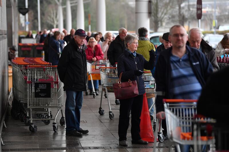 Shoppers queue outside a Sainsbury's supermarket prior to opening in Plymouth, south-west England. Reuters