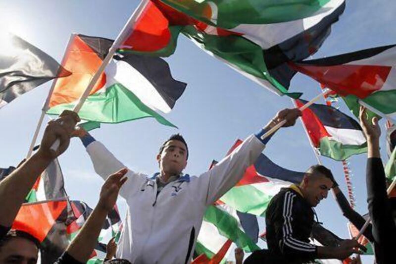 Palestinians in the West Bank city of Ramallah celebrate their successful bid to win UN statehood recognition. Israel has already announced it is to build thousands of settler homes, rejecting the borders of a future Palestinian state the UN endorsed.