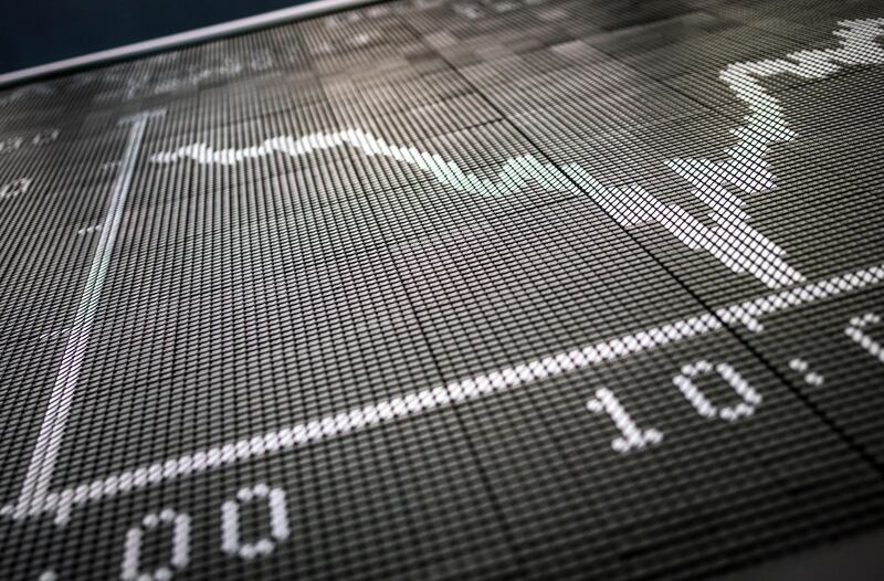The Dax curve displayed on a blackboard in the trading room of the stock exchange shows a strong downward trend in the morning at the trading room of the stock exchange in Frankfurt, Germany, Wednesday, Feb. 26, 2020. (Frank Rumpenhorst/dpa via AP)
