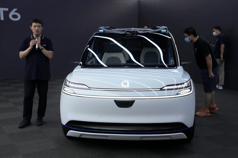 Xu Baoqiang, general manager of Baidu's Autonomous Driving Unit, talks about the Apollo RT6 as he addresses journalists in Beijing on Wednesday. AP
