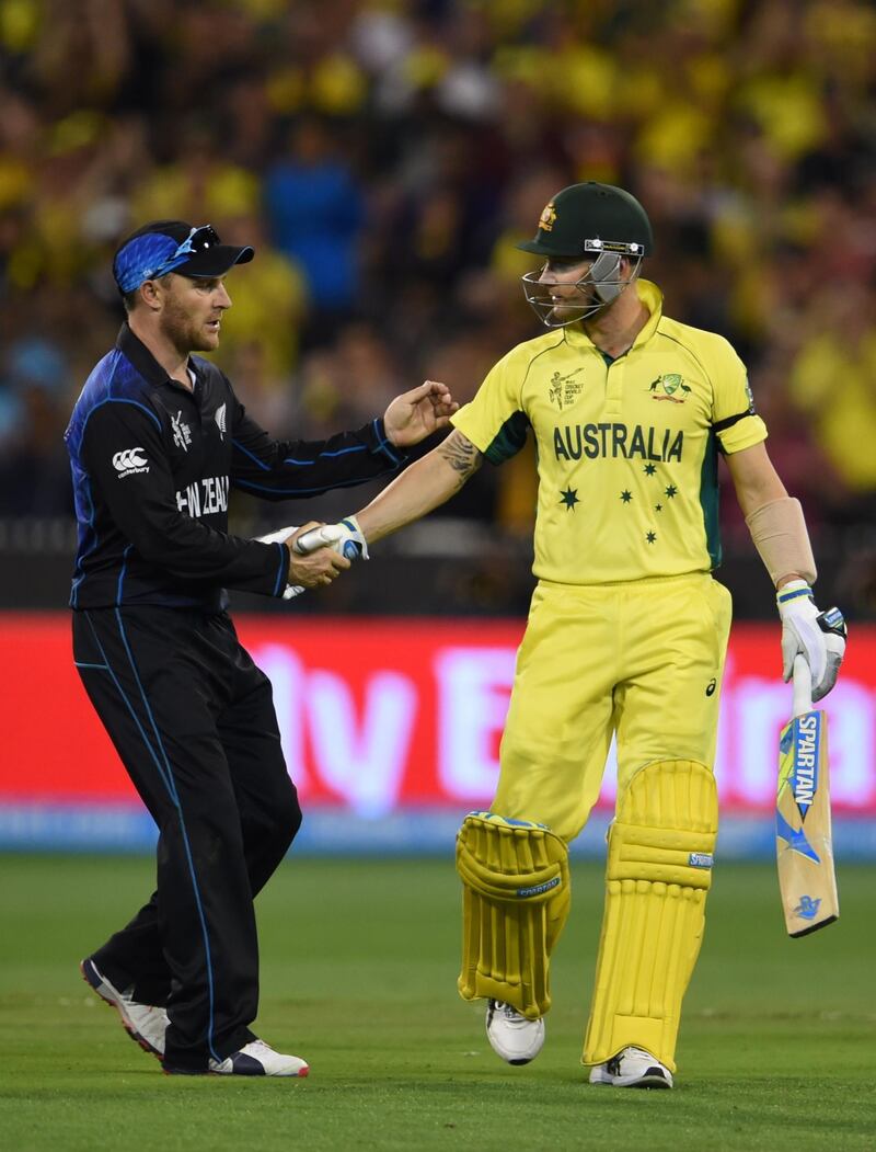 Australia's batsman Michael Clarke (R) shakes hands with New Zealand's captain Brendon McCullum in his last cricket one-day international as Australia close in on a World Cup final victory against New Zealand in Melbourne on March 29, 2015. --IMAGE RESTRICTED TO EDITORIAL USE - STRICTLY NO COMMERCIAL USE-- (Photo by WILLIAM WEST / AFP)