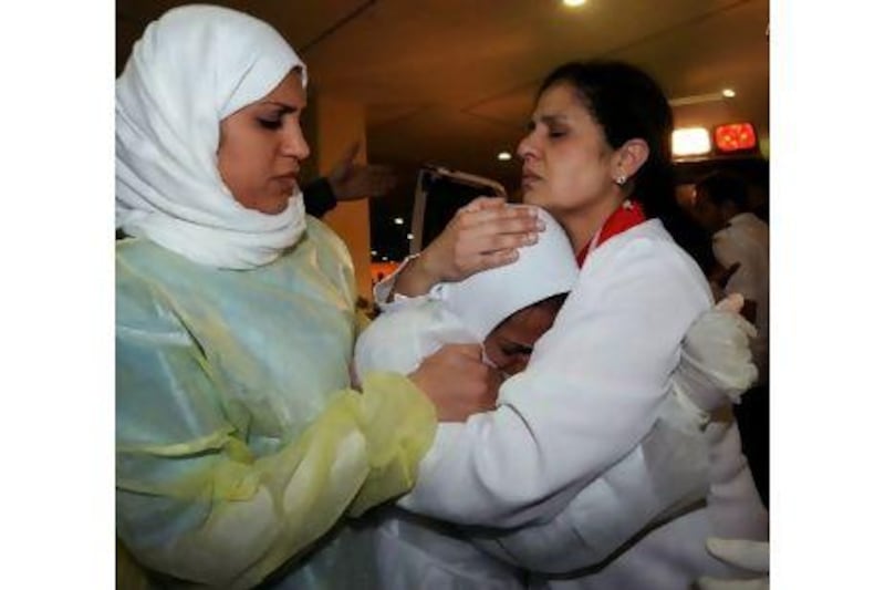 Nurses comforting a fellow nurse after she was threatened by police at Salmaniya Medical Complex in Manama, Bahrain earlier this year. MAZEN MAHDI / EPA