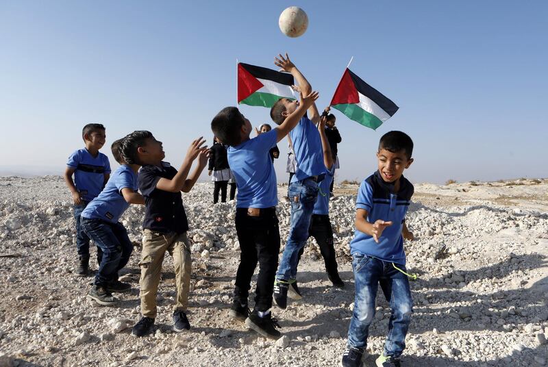 Palestinian students play outdoors during the first day of school in the West Bank village of Khalat Aldabie, east of Yatta. Abdel Al Hashlamoun/EPA