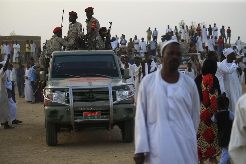 A technical (pickup truck mounted with a machine gun turret) carrying members of Sudan's Rapid Support Forces (RSF) paramilitaries drives by during a rally in the village of Qarri, about 90 kilometres north of Khartoum.  AFP