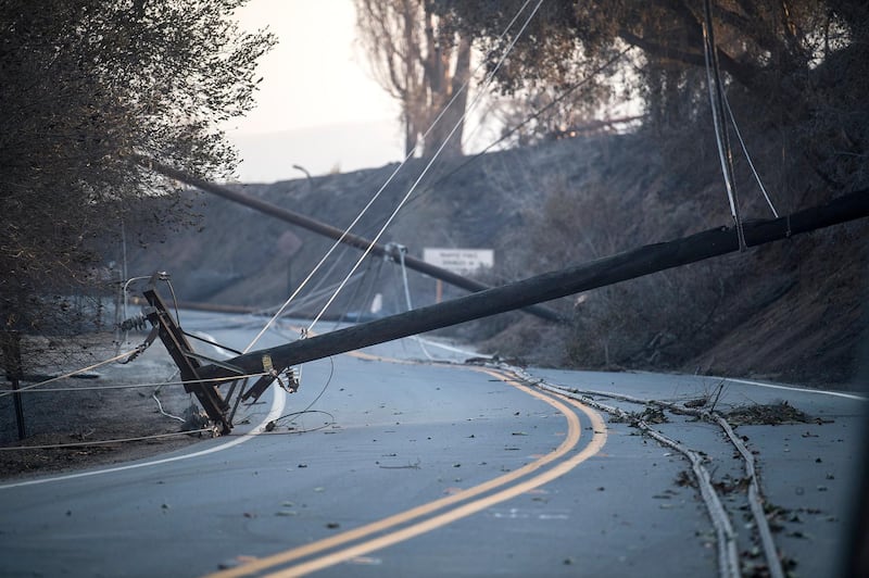 Burned and fallen power poles lay on a road during the 'Thomas Fire' which began overnight in Ventura, California. John Cetrino / EPA