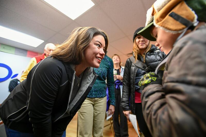 Democrat Angie Craig, who's campaigning for US House district 2, talks with a young supporter at her campaign office in Burnsville, Minnesota. EPA
