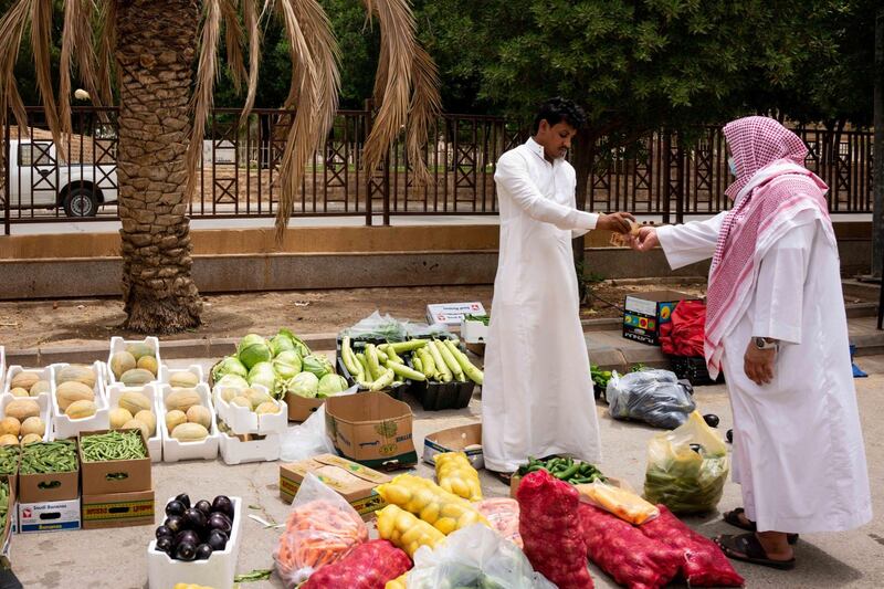 A street vendor sells fruit and vegetables on a roadside in Riyadh, Saudi Arabia, on Tuesday, May 19, 2020. Hit simultaneously by plunging crude prices and coronavirus shutdowns, the non-oil economy is expected to contract for the first time in over 30 years. Photographer: Tasneem Alsultan/Bloomberg