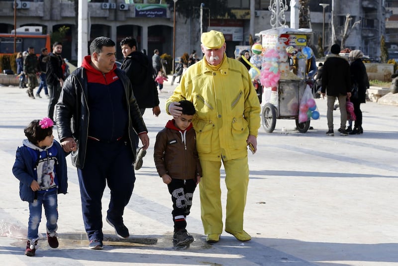 Zakkour walks along with pedestrians in the central square