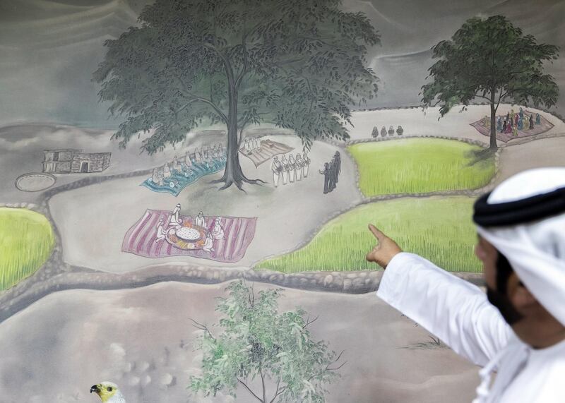 RAS AL KHAIMAH, UNITED ARAB EMIRATES. 23 NOVEMBER 2020. 
Saeed Al Dhahouri points at a mural on the walls of a majlis in his heritage village. He commisioned a South Asian artist who resides in RAK for this mural.

In the valley of the village of Shaam, Saeed Al-Dhahouri is keen to educate the rising generation about UAE’s heritage; and for that he has set up Muhammad Bin Rashid Heritage Village in Wadi Shaam.

The village includes many old traditional UAE tools that the people of the mountain used in the past, and showcases customs, traditions and practices inherited from older generations.

Al-Dhahouri has devoted his efforts to transforming his farm into a heritage village since 1995.

(Photo: Reem Mohammed/The National)

Reporter: ANNA ZACHARIAS
Section: NA NATIONAL DAY