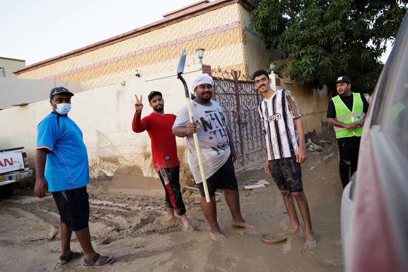 Residents on a street during a clean-up drive.