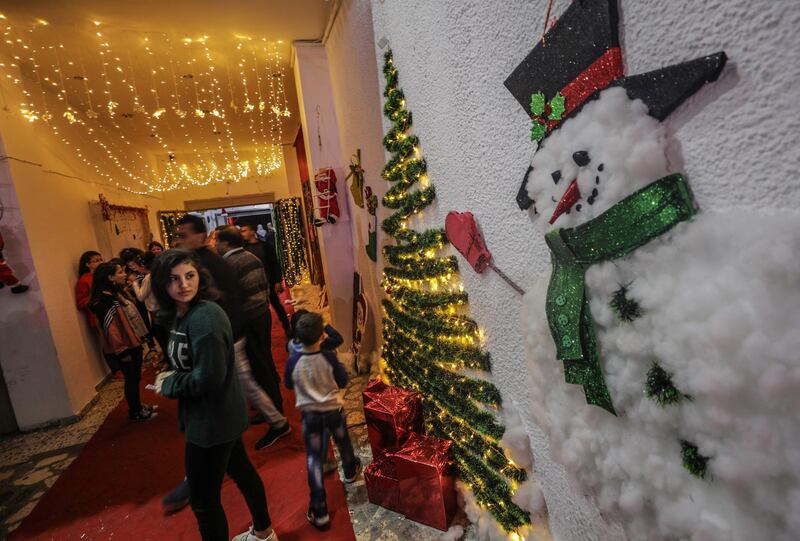 epa08042304 Palestinian youth attend a ceremony of lighting a Christmas tree in Gaza City, 03 December 2019. The event was organised by the YMCA Gaza.  EPA/MOHAMMED SABER
