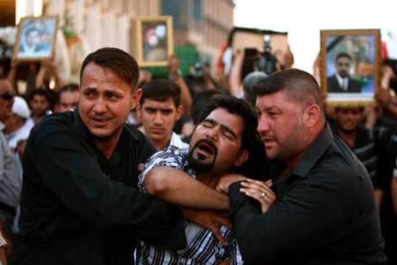 Iraqi mourn slain Shiite pilgrims during a funeral in the holy city of Karbala, 80 kilometers (50 miles) south of Baghdad, on September 13, 2011. Gunmen killed 22 Shiite Muslim pilgrims on their way to Syria as they were passing through a predominantly Sunni Iraqi province from the shrine city of Karbala, officials said.
AFP PHOTO/MOHAMMED SAWAF
 *** Local Caption ***  826194-01-08.jpg