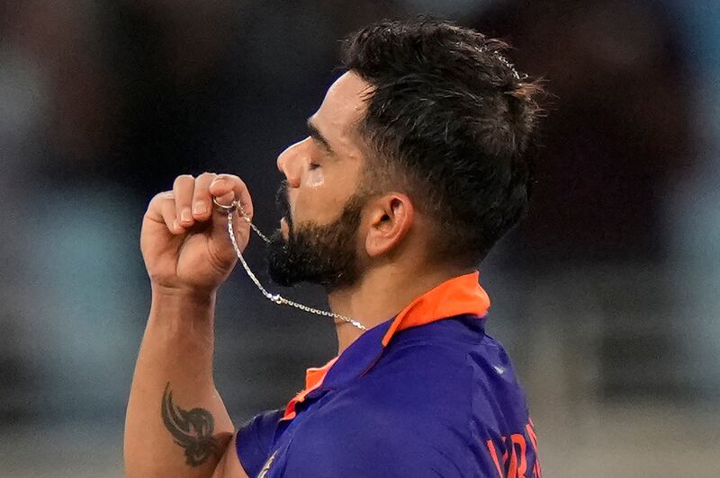 India's Virat Kohli kisses a ring as he celebrates his century against Afghanistan in Dubai. AP