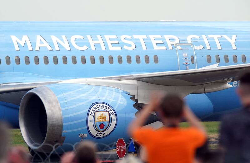 The Boeing 787-9 Dreamliner carrying the Manchester City players lands at Manchester Airport after their victory in the UEFA Champions League final in Istanbul. PA