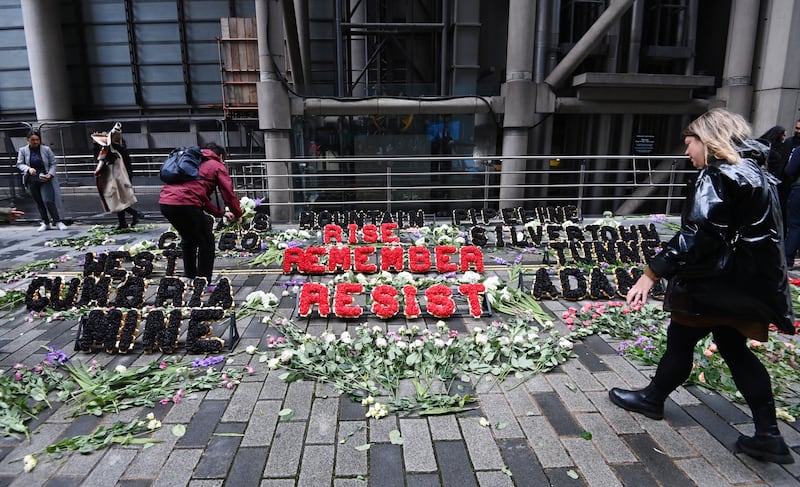 Environmental protesters leave flowers outside Lloyds of London insurance market. EPA