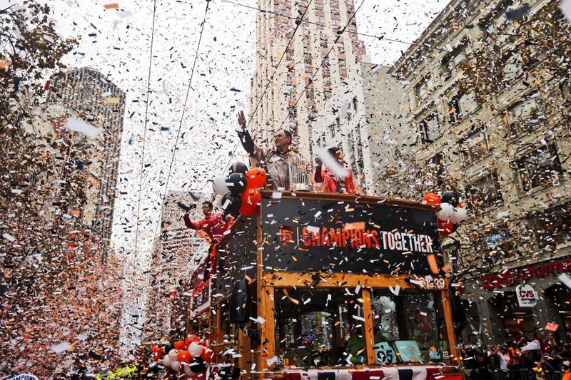 San Francisco Giants manager Bruce Bochy, top center, waves as he carries the 2014 World Series trophy during the victory parade for baseball's 2014 World Series champions on Friday in San Francisco. AP Photo/Marcio Jose Sanchez