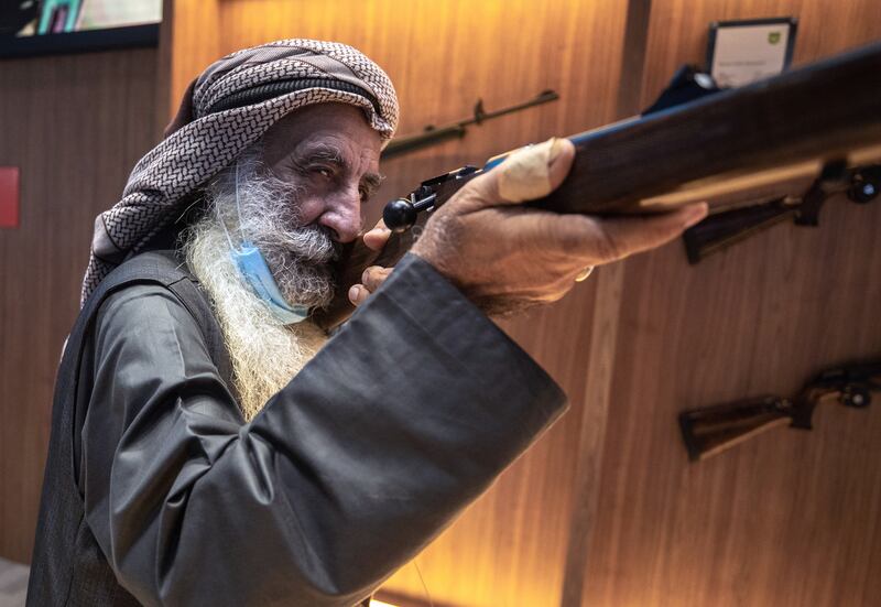 Ali Mohammad Al Shehhi, a veteran marksman, checks out some rifles at the Caracal stall at the Abu Dhabi International Hunting and Equestrian Exhibition. Victor Besa / The National