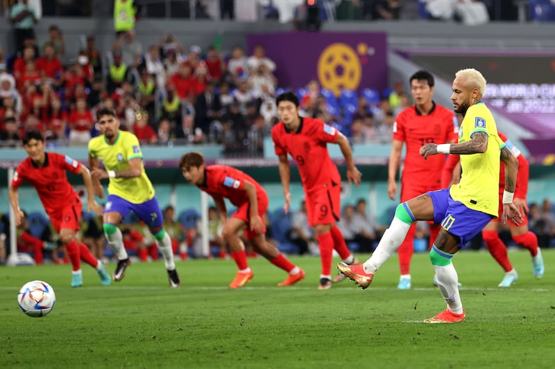 Neymar of Brazil scores from the spot. Getty