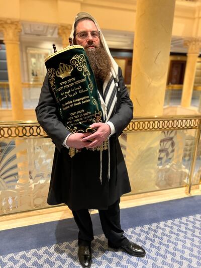 Jacob Herzog, who claims to be the chief rabbi of Saudi Arabia, holds the Torah. Photo courtesy of Rabbi Herzog