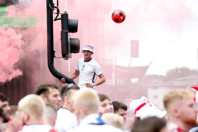 England fans with flares gather outside Wembley stadium ahead of the Euro 2020 final against Italy.